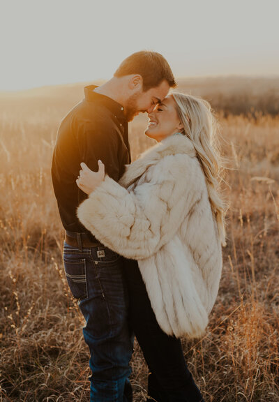 bride and groom embracing in grass