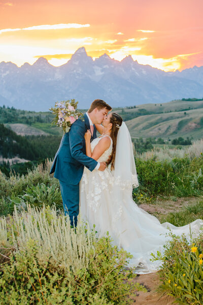 Jackson Hole wedding photographer captures couple kissing in Jackson Hole after sunset