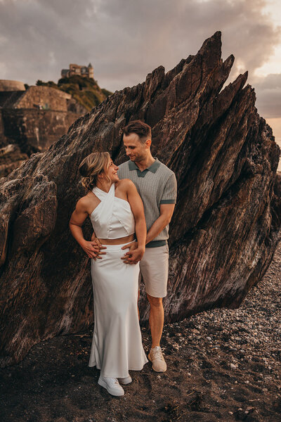 bride and groom pose on beach