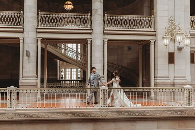 groom leads bride by the hand