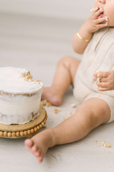 1st birthday baby boy enjoying naked smash cake