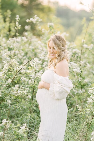 Pregnant mom outdoors in wildflower field for Louisville maternity photography session