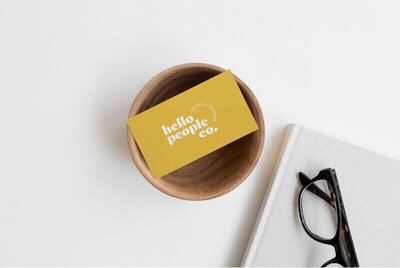 Yellow business card sitting on a bowl