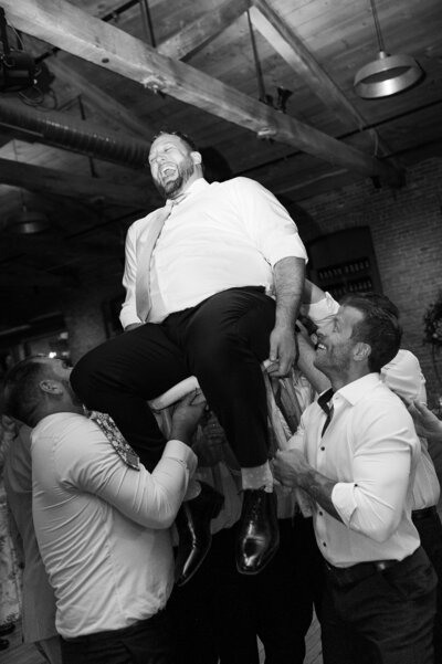 groom having fun at wedding at city winery