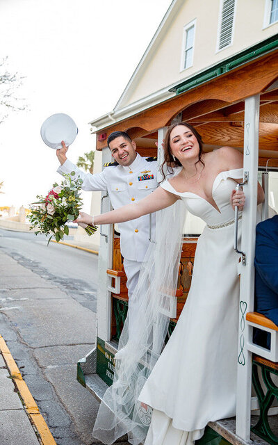 Couple waving goodbye at their wedding in a St Augustine trolley getaway