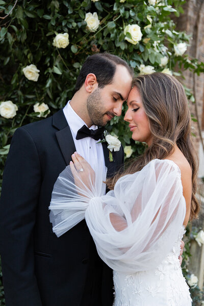 a bride and groom in formal wedding attire embracing