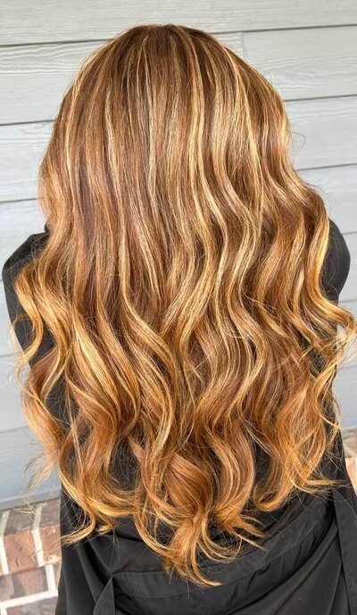 Close-up of lived-in strawberry blonde waves, showcasing Maven + Grace’s signature color work and attention to hair health.
