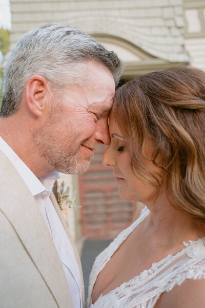 bride and groom look at each other like they are proud