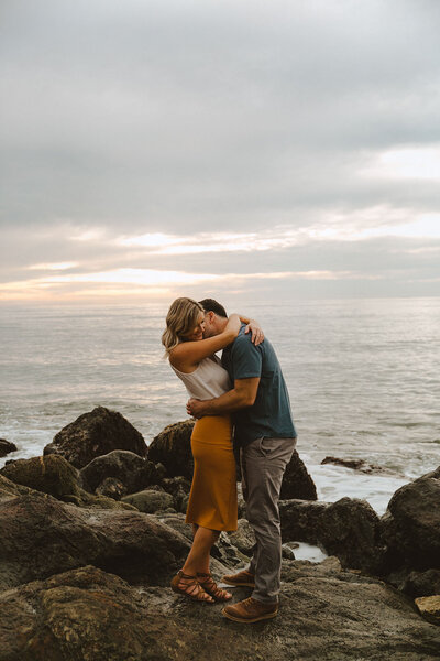 couple kissing on shoreline