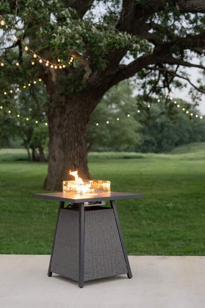 Firepit lit during cocktail hour recpetion patio at The Era Central Iowa Wedding Venue