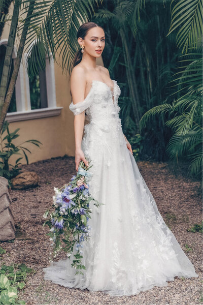 Get ready to turn heads in this delicate gown of soft netting and ethereal lace details. Topped off with a plunging v-neck bodice of Jezzie lace.