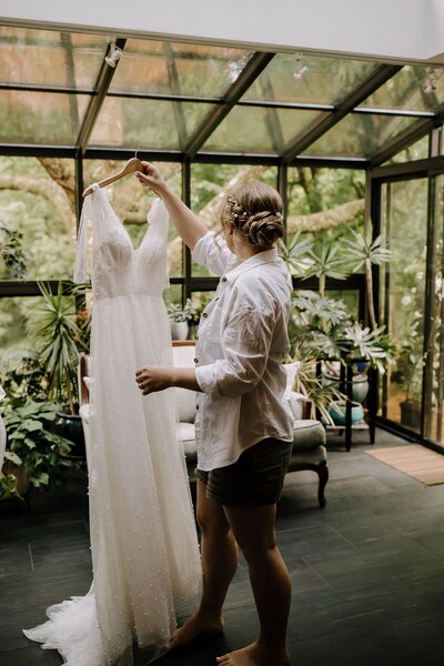 Bride getting dress ready to put on