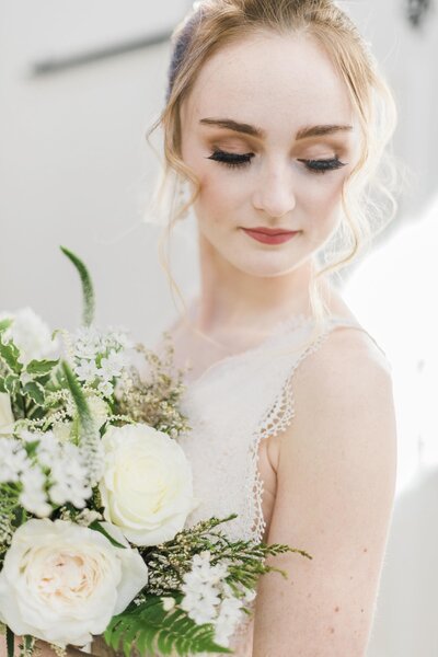 blonde bride holding bouquet