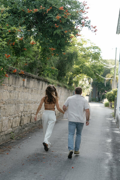 Couple running down a street taken by east coast photographer Shelby Ann Photos
