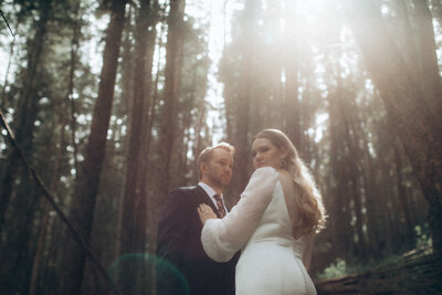 Classic portrait of bride and groom holding hands in the mountains, captured by Tim & Court Photo and Film, joyful and adventurous wedding photographer and videographer in Calgary, Alberta. Featured on the Bronte Bride Vendor Guide.
