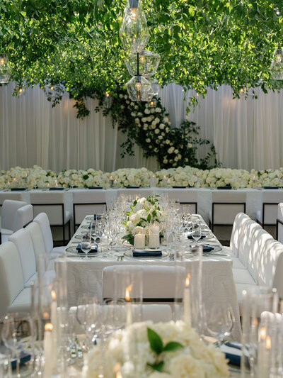 Ballroom wedding reception at Ritz Carlton Bacara  with white carpet and draping, and olive tree table centerpieces
