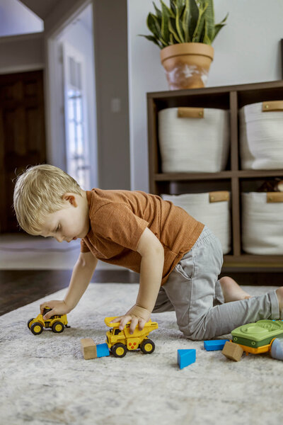 a preschool boy in carrollton texas plays with his toy cars