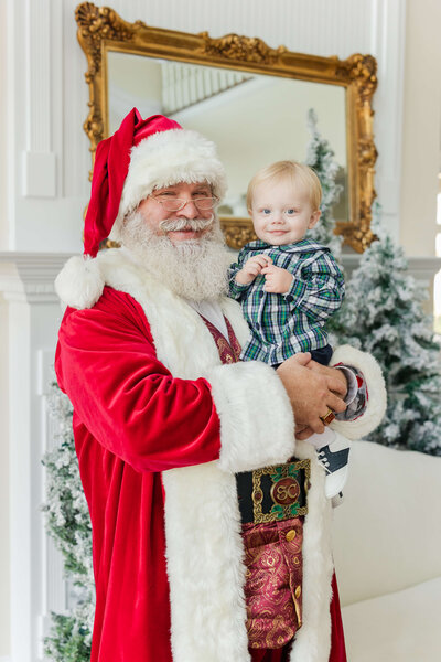 Santa holding toddler for santa mini sessions in dothan alabama