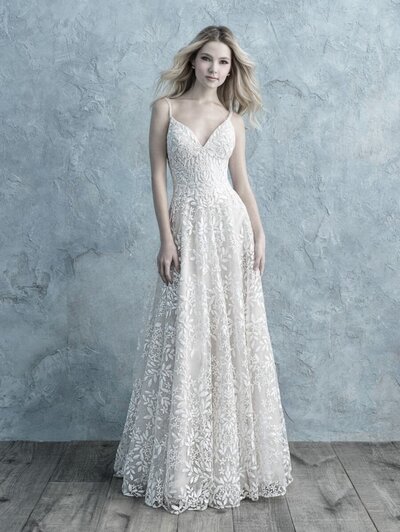 The slim silhouette of this strapless gown is textured with lace appliques.