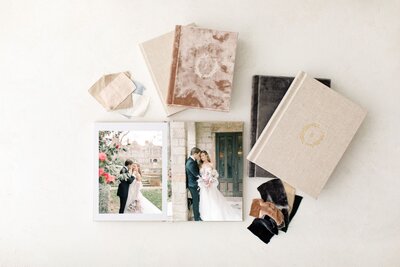 Wedding album laid out with album swatches on table.