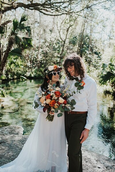 Couple walking into the Lightner Museum fountain to splash around at the end of their Saint Augustine elopement