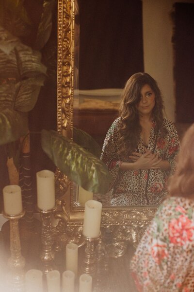 Luna Skye looking in mirror holding heart