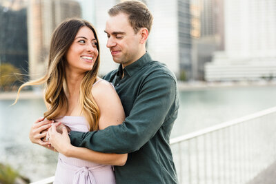 Couple embrace along the river front during their engagement session in Austin, Texas. Photo taken by Austin Engagement Photographers, Joanna & Brett Photography