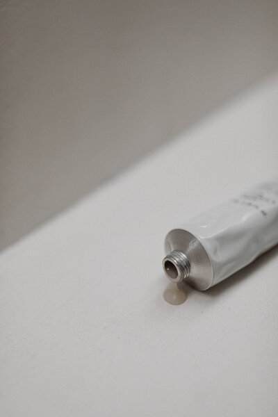 kaboompics_ugc-style-image-of-a-hand-and-body-scrub-tube-on-a-neutral-background-free-stock-photo-34706