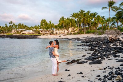 Couple embracing on the beach after a surprise proposal at the Fairmont Orchid on the Big Island of Hawaii, photographed by Hawaii Adventure Portraits, a Hawaii proposal photographer
