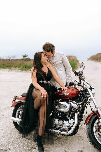 couples sits on motorcycle