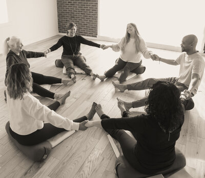 yogis in a circle holding hands