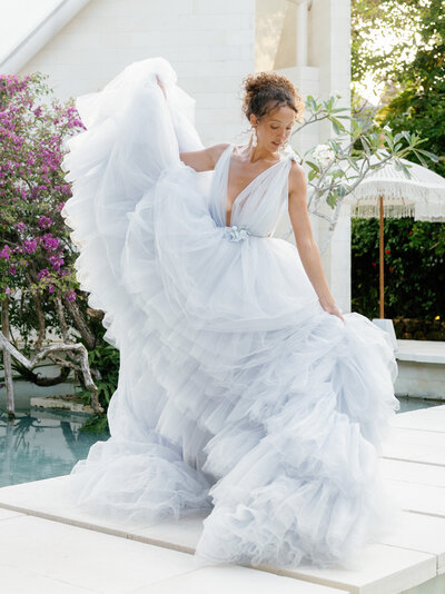 bride holding dress in Bali during wedding photography service