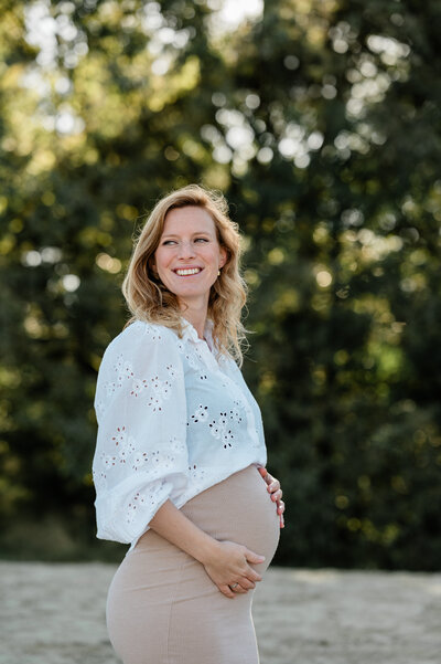 en zwangere vrouw poseert tijdens een intieme zwangerschapsfotoshoot, gefotografeerd door Monica Stout Fotografie in Rotterdam en Sliedrecht.