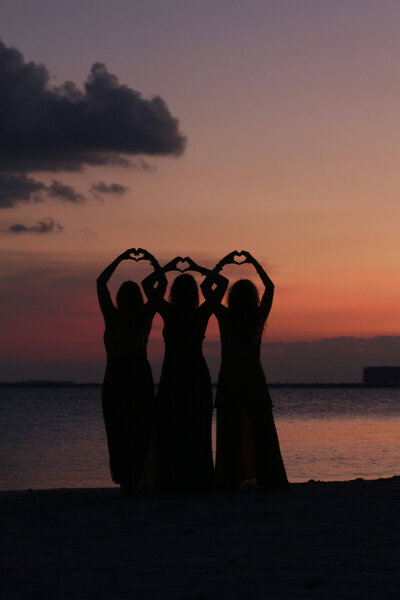 Nurses Healing Nurses healing with chakras and standing together with heart-shaped hands in the sunset