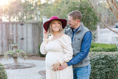 mom and dad looking at each other at Cypress Gardens for maternity pictures