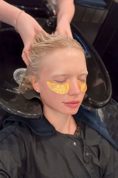 Blonde hair being washed at a salon basin during a pampering session, showcasing professional hair treatments and styling services at Blake & Kwan Hair Salon.