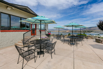 Tables and chairs outside Celilo Inn in a sunny day