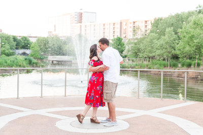 Photo of an engaged couple kissing at Historic Fourth Ward Park in Atlanta Georgia.