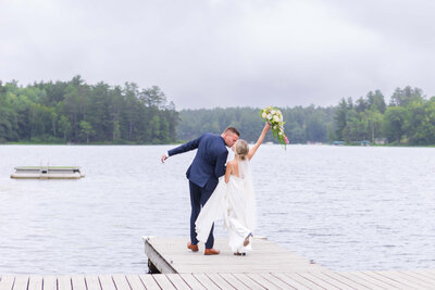 Stylish bride & groom walking on dock