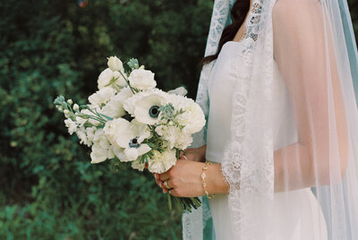 Bride waits in excitement  for her first look and her bridesmaids do up her dress