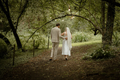 Woodland photography in Devon featuring bride and groom walking