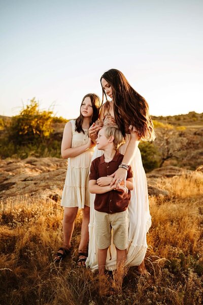 mom and son pose for Paula Goforth Photography at murrell park, they are close together snuggling.