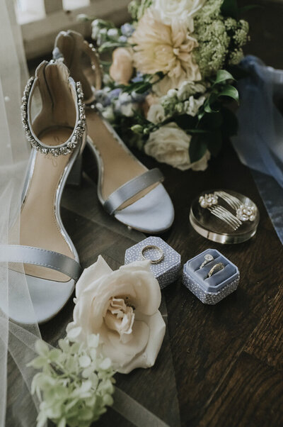 bridal shoes, ring box, flowers, and other wedding details