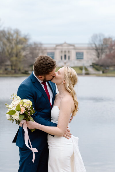 Elopement couple kissing at Wade Lagoon in Cleveland.