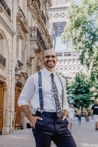 Wedding Photographer  wearing nice suit in front of the Eiffel Tower