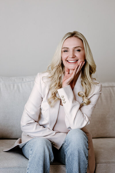 Female headshot smiling at the camera wearing a suit