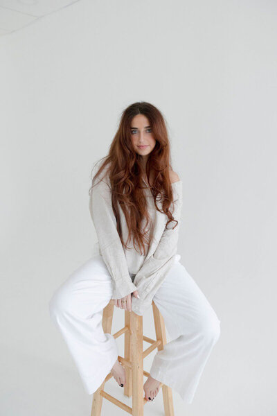 Orlando photographer, Marissa Nicole, sitting on a stool