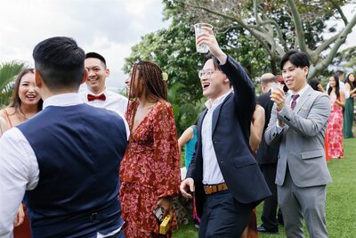 Wedding guests laughing and celebrating at a reception 