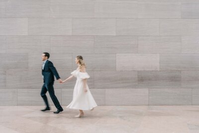 bride and groom hold hands wondering around in National Gallery. of Art in Washington D.C.