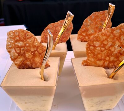 Orange risotto with caramel cream and orange flavored tuile cookie for dessert bar buffet